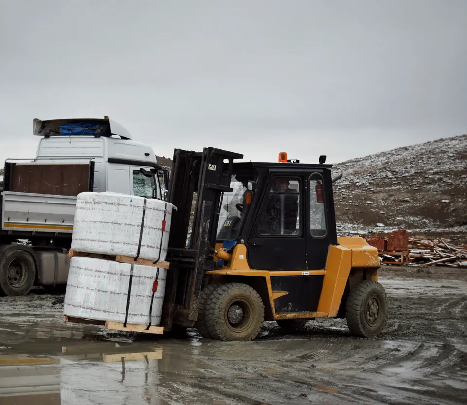 Forklift loading pallets onto a truck