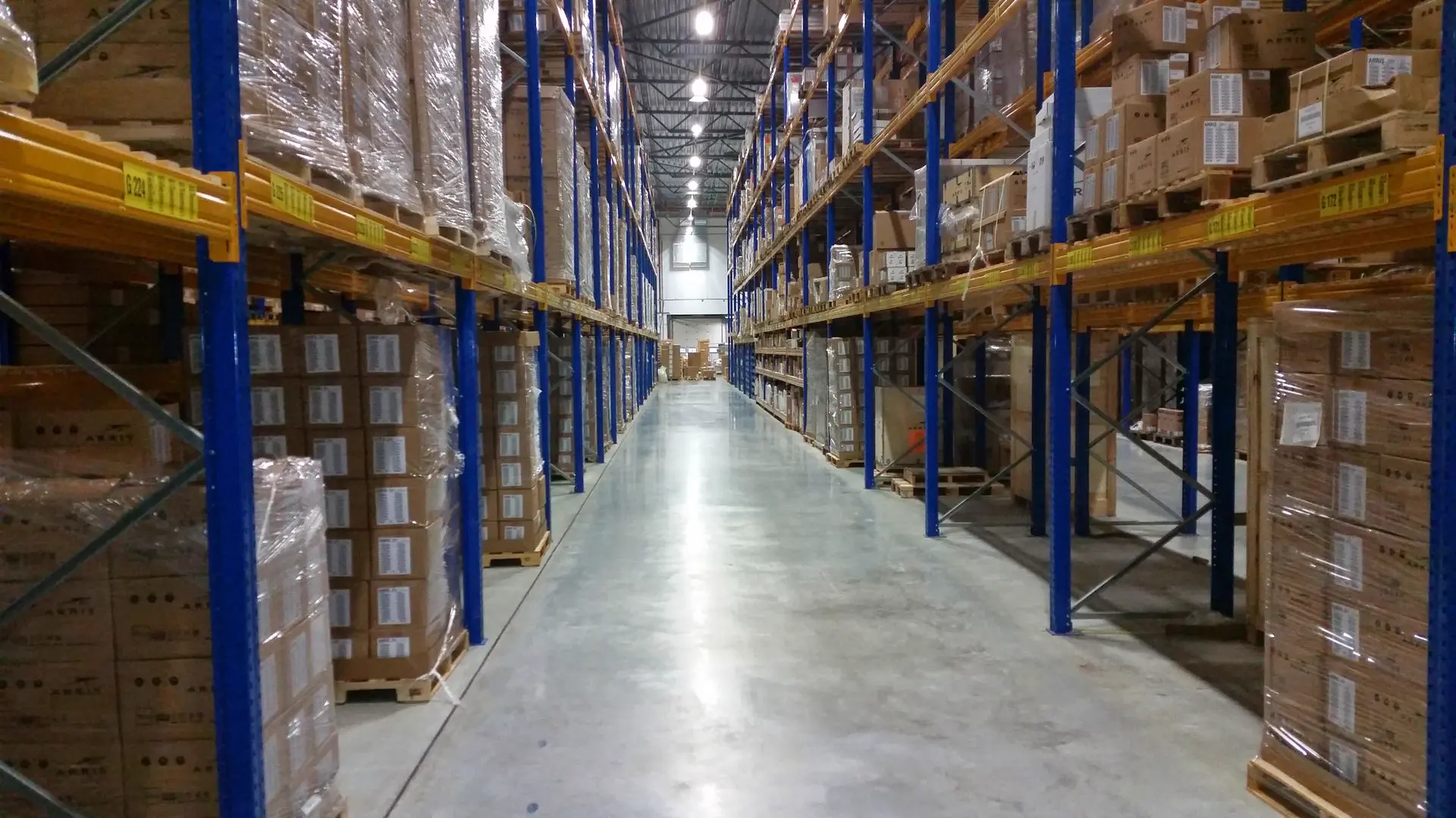 Warehouse aisle between tall pallet racks